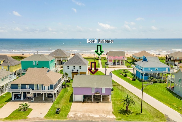 bird's eye view with a water view and a beach view