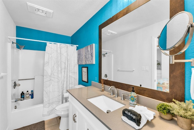 full bathroom with tile patterned floors, toilet, shower / tub combo, a textured ceiling, and vanity