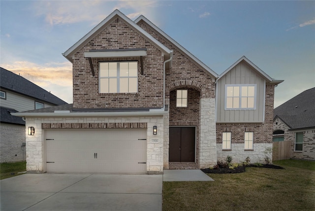 view of front of house with a garage and a yard