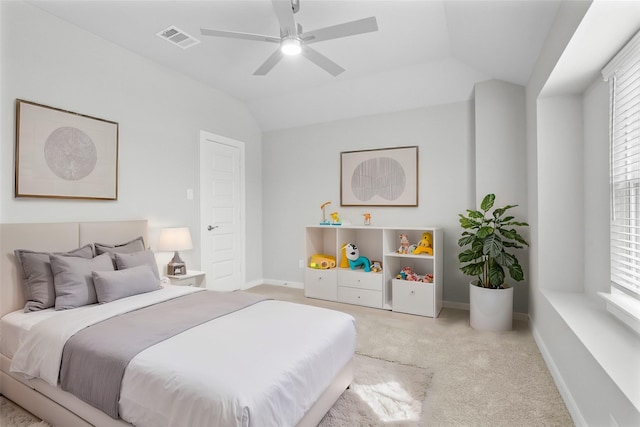 carpeted bedroom with vaulted ceiling and ceiling fan