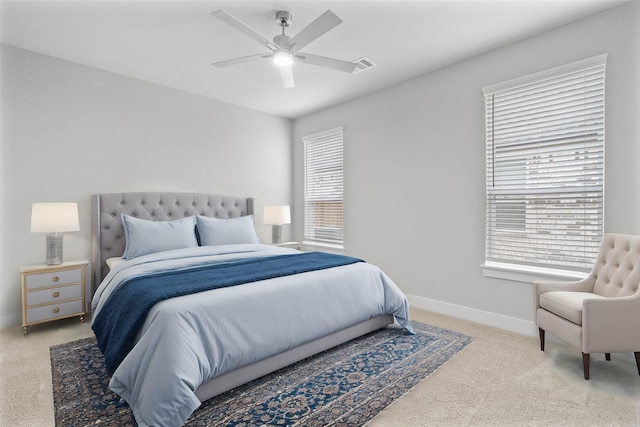 carpeted bedroom featuring ceiling fan and multiple windows