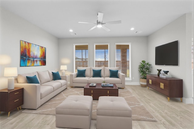 living room featuring ceiling fan and light hardwood / wood-style flooring