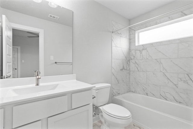 full bathroom with tiled shower / bath combo, vanity, and toilet