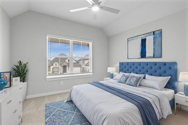 carpeted bedroom with vaulted ceiling and ceiling fan