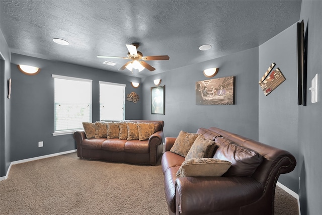 carpeted living room featuring a textured ceiling and ceiling fan