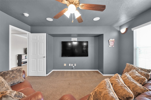 carpeted living room featuring a textured ceiling and ceiling fan