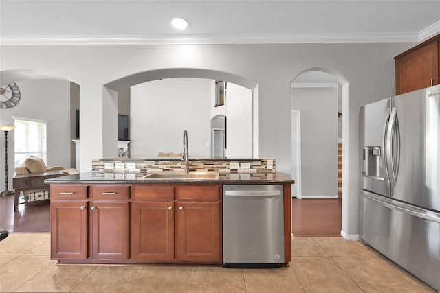 kitchen featuring light hardwood / wood-style floors, sink, backsplash, and stainless steel appliances