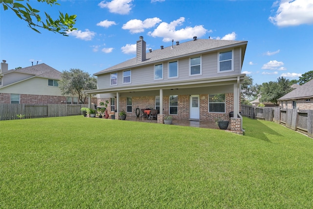 back of property featuring a patio area and a yard