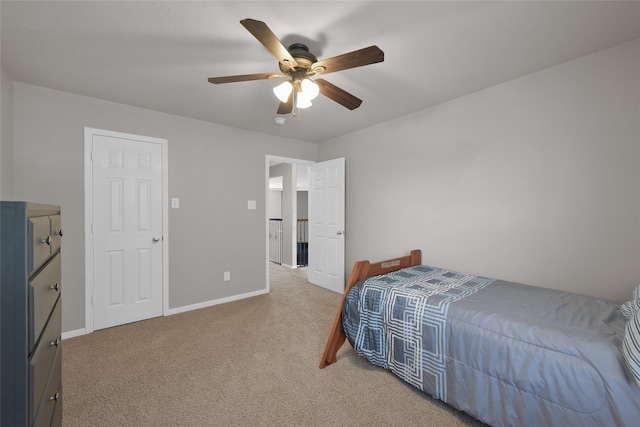 bedroom featuring light colored carpet and ceiling fan