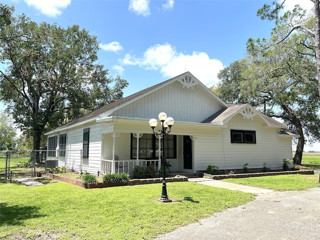 view of front of house with a front yard and a porch