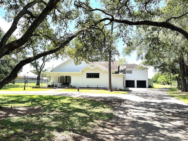 view of front of property with a front yard and a garage