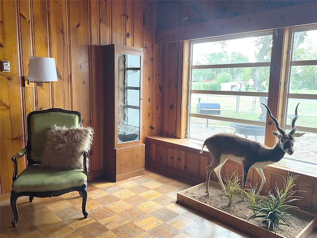 living area featuring wood walls