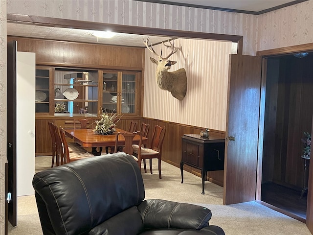 living room featuring light carpet and wood walls