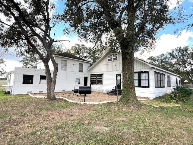 rear view of property featuring a yard