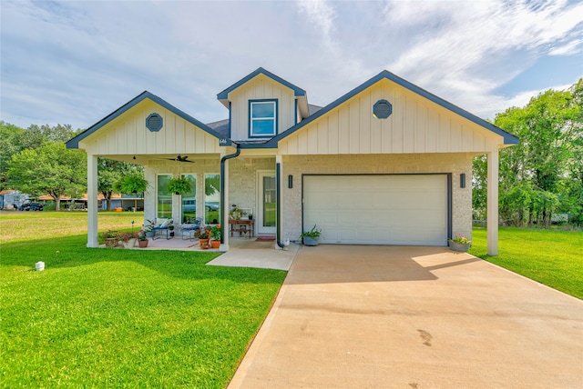 view of front of property with a porch, a front lawn, ceiling fan, and a garage