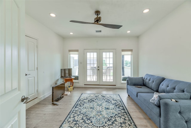 living room featuring ceiling fan, light wood-type flooring, and french doors