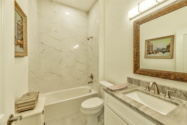 full bathroom featuring tiled shower / bath combo, vanity, and toilet