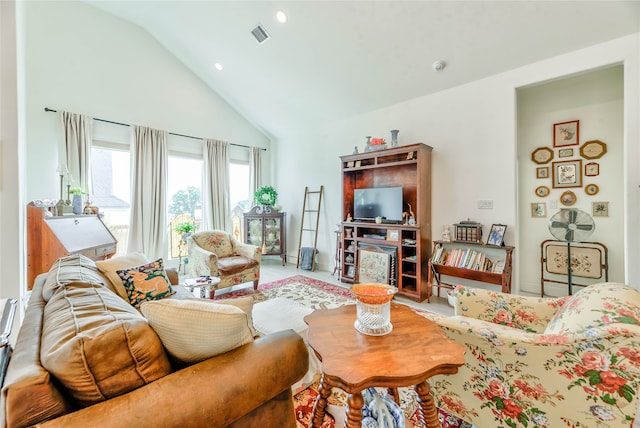 living room featuring high vaulted ceiling