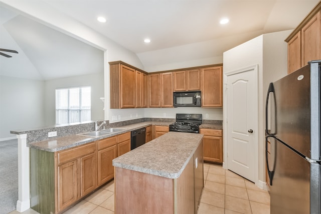 kitchen featuring light colored carpet, vaulted ceiling, ceiling fan, black appliances, and a center island