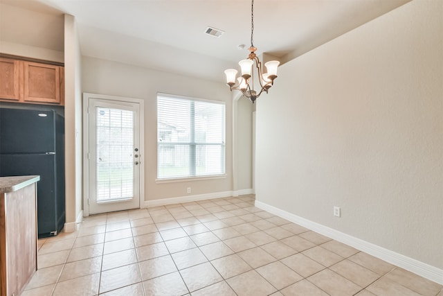 interior space with light tile patterned floors and a chandelier