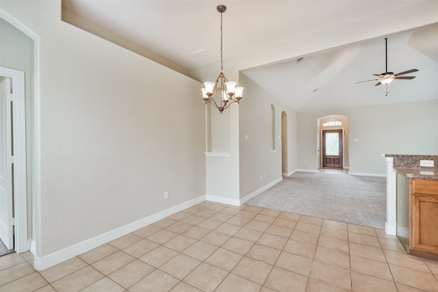 interior space featuring ceiling fan with notable chandelier and vaulted ceiling