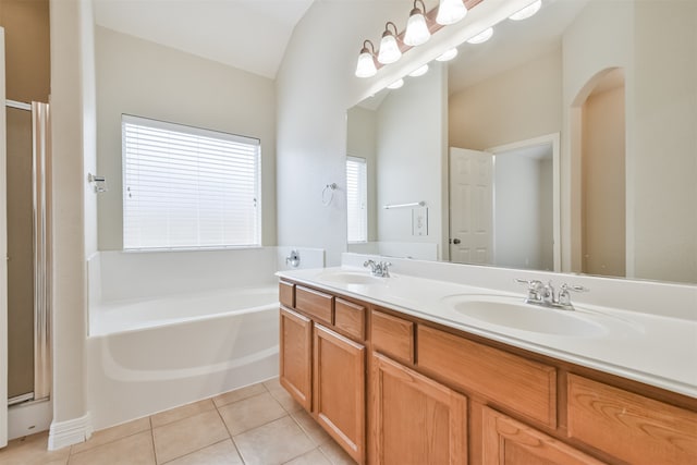 bathroom featuring dual vanity, tile patterned flooring, vaulted ceiling, and separate shower and tub