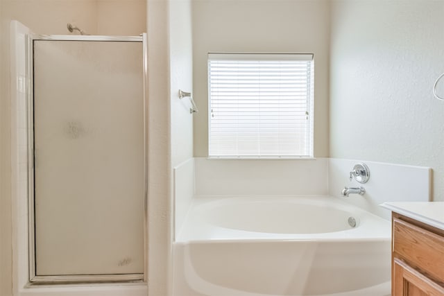 bathroom with plus walk in shower and vanity