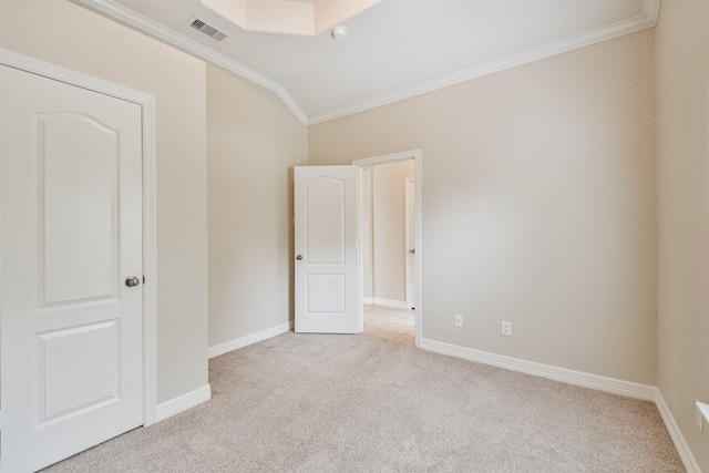 carpeted spare room featuring crown molding