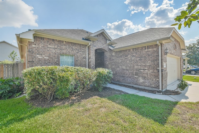 view of front of home with a front yard and a garage