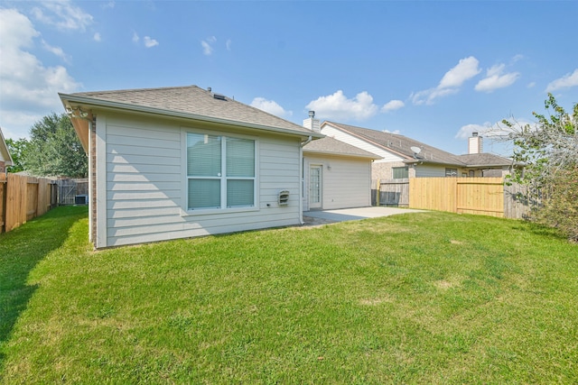 back of house with a patio area and a yard