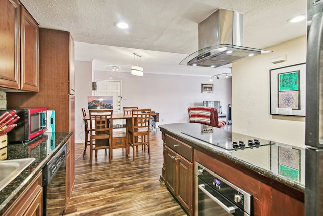 kitchen featuring island exhaust hood, pendant lighting, dark hardwood / wood-style flooring, a textured ceiling, and black appliances