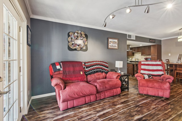 living room with hardwood / wood-style floors, crown molding, and track lighting