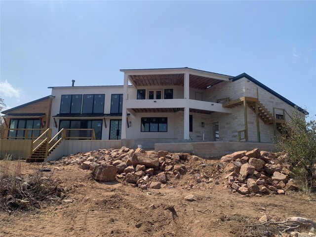 rear view of property featuring a balcony