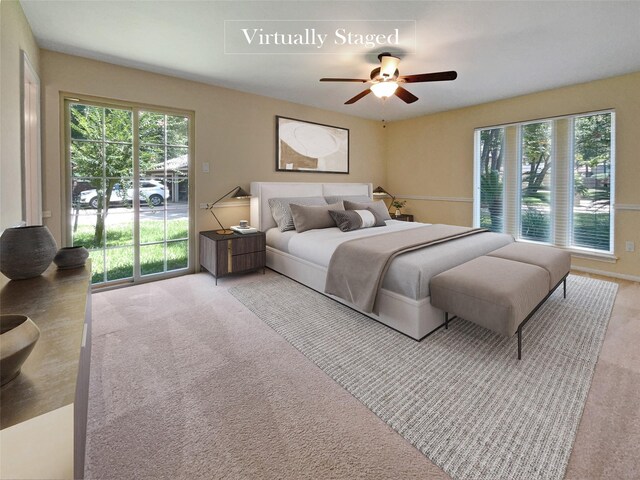 bedroom with access to outside, light colored carpet, and ceiling fan