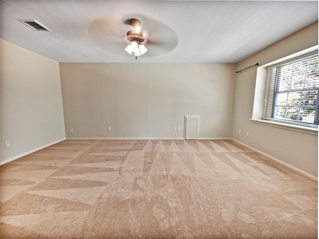 carpeted empty room featuring ceiling fan