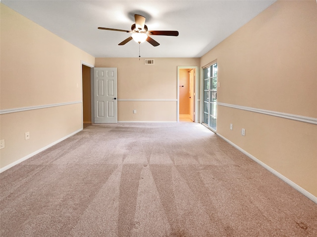 carpeted spare room with ceiling fan