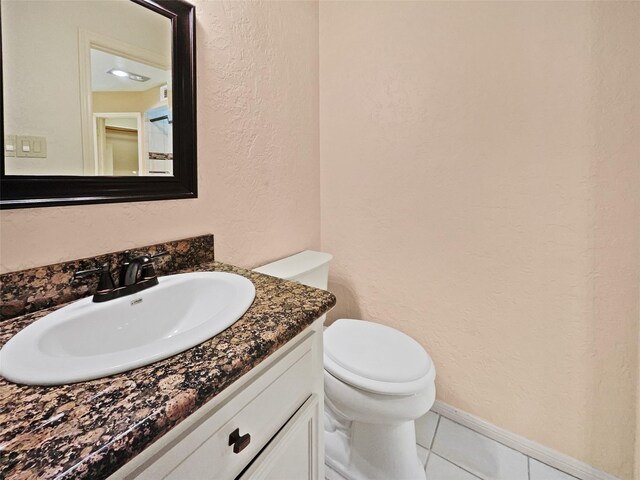 bathroom with tile patterned floors, toilet, and vanity