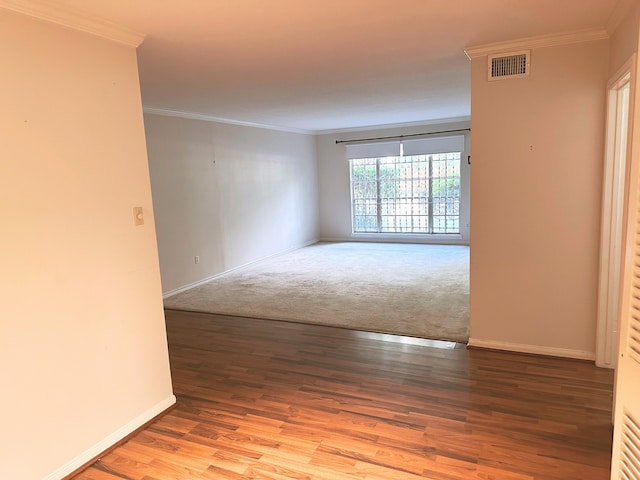 carpeted empty room featuring crown molding