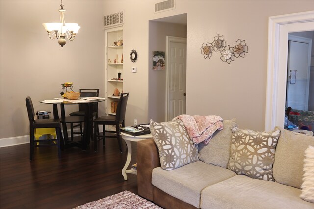 living room with a chandelier and dark wood-type flooring