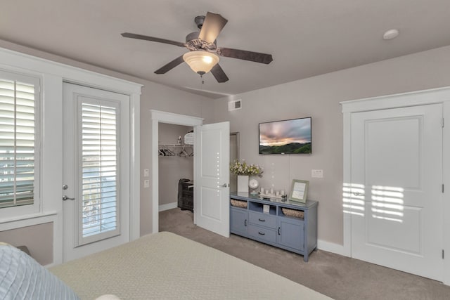 carpeted bedroom with ceiling fan and a closet