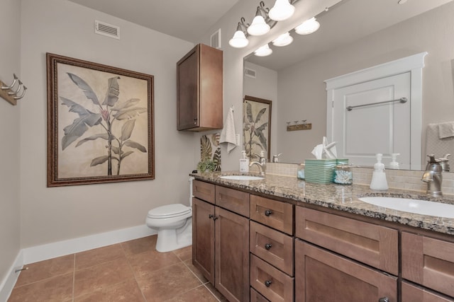 bathroom with toilet, tile patterned flooring, and dual bowl vanity