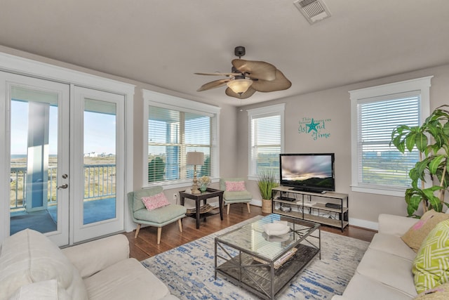 living room with french doors, hardwood / wood-style floors, and ceiling fan