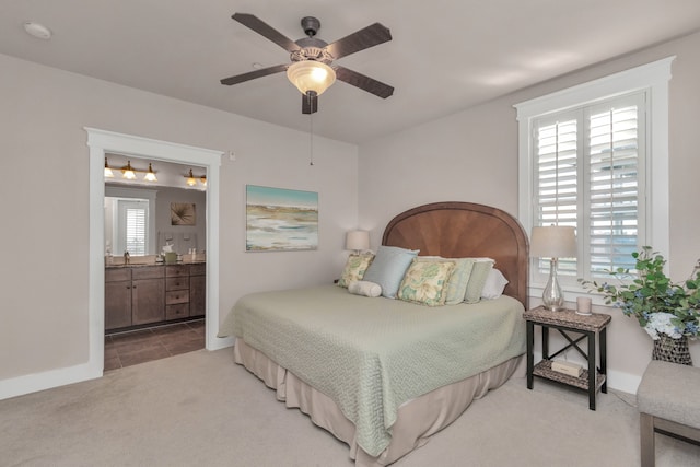 bedroom with ensuite bathroom, ceiling fan, and carpet flooring