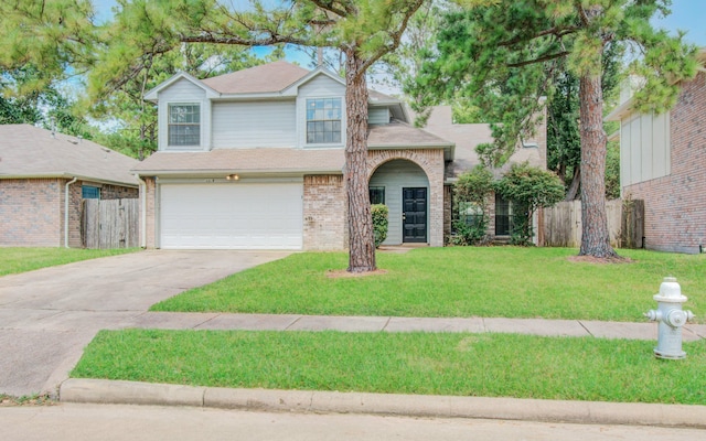 view of front of property with a front yard and a garage