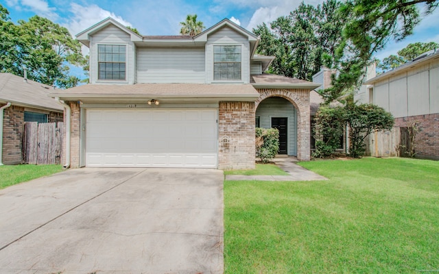 view of front of property featuring a garage and a front yard