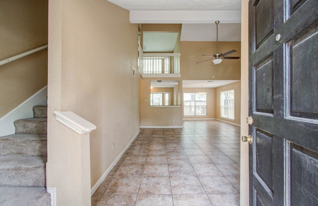 entrance foyer featuring ceiling fan and light tile patterned floors