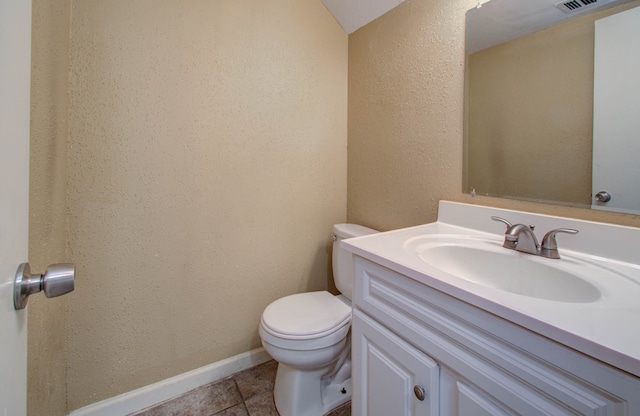 bathroom with vanity, toilet, and tile patterned floors