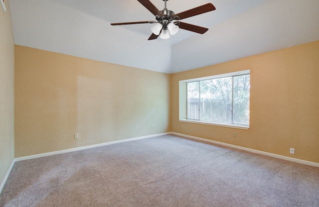 carpeted empty room featuring ceiling fan and vaulted ceiling