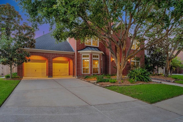 view of front of house featuring a garage and a lawn