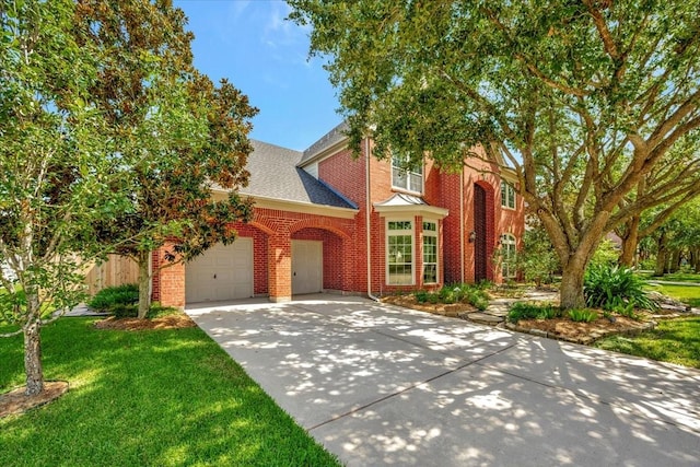 view of front of house with a garage and a front yard